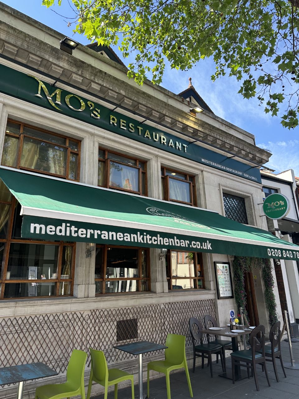 MO's Restaurant gold signage and green awning facade