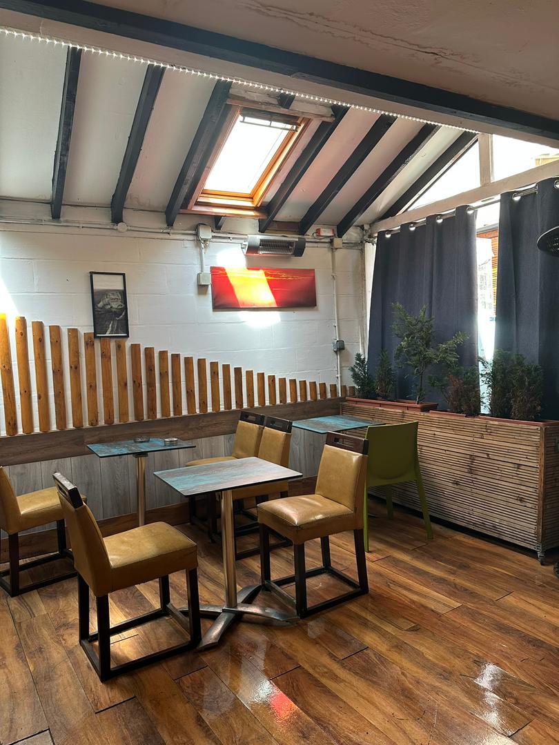 Bright covered terrace with skylight seating