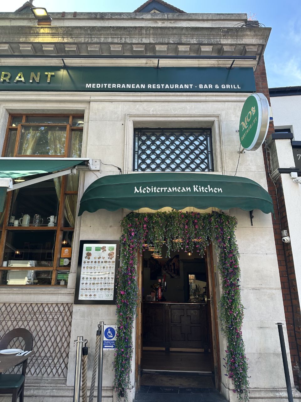 Mediterranean Kitchen entrance with flower-draped doorway