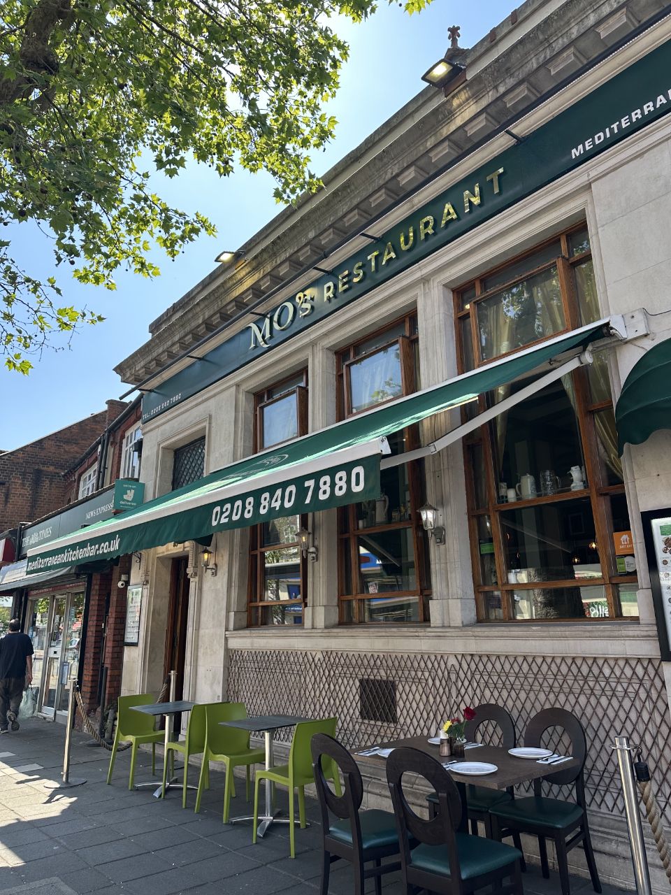 MO's exterior terrace seating under the green awning