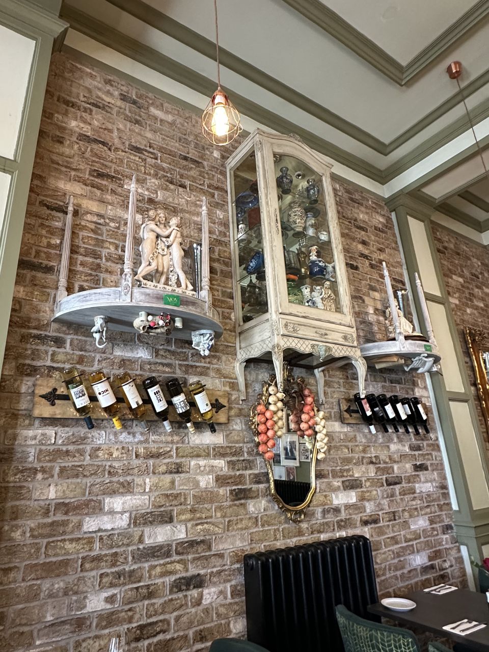 Exposed brick wall with antique display and wine racks