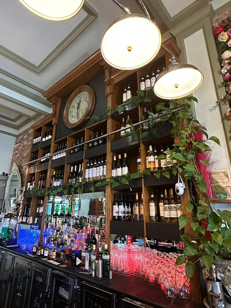 Vintage clock and wine display above the bar