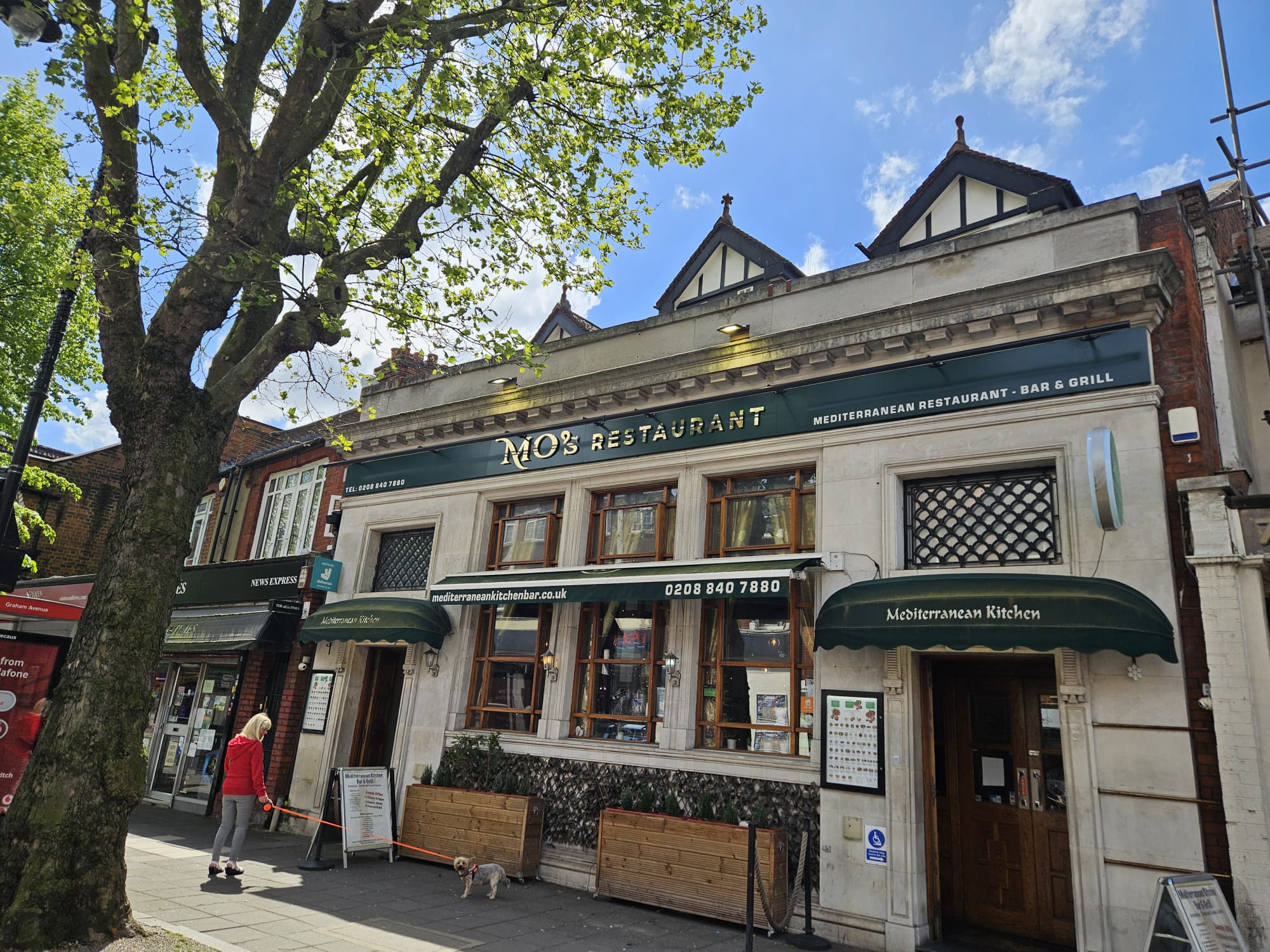 Full view of MO's Restaurant building and pavement terrace
